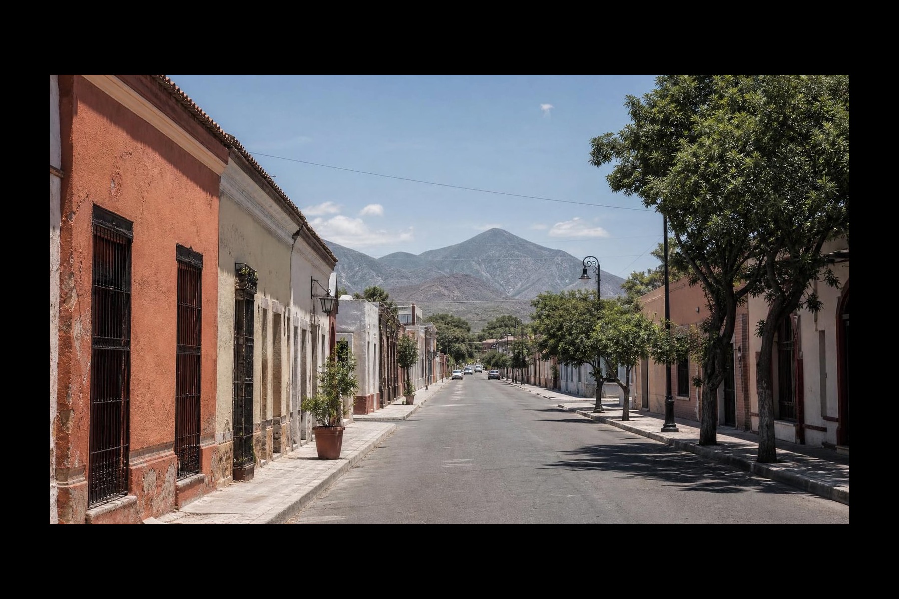 Clear November street near Linares historic center with Sierra Madre foothills beyond Nuevo Leon rooftops