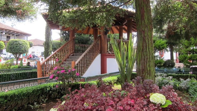 Wooden kiosk surrounded by flower beds and trees in Mazamitla's main square
