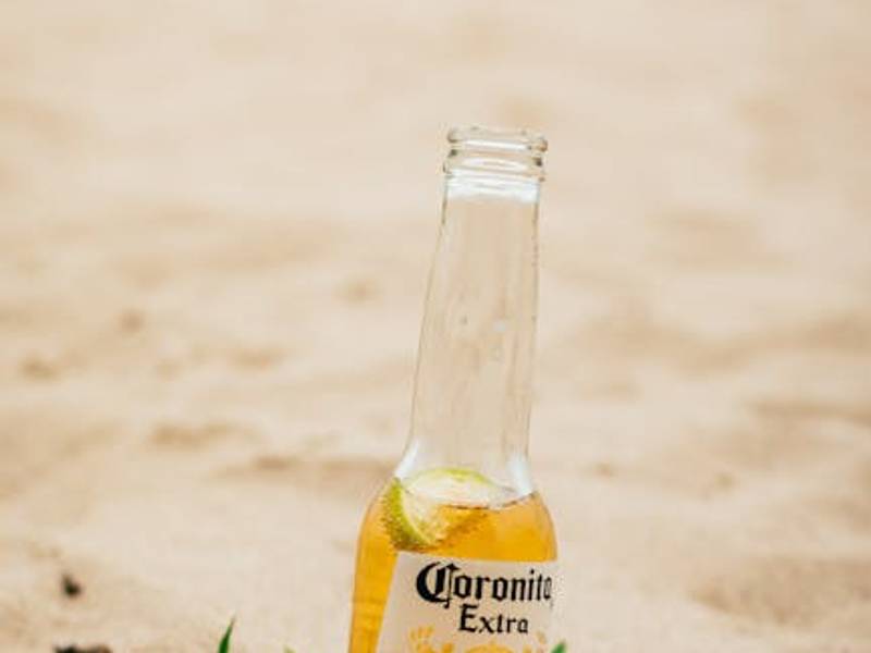 Mexican beer bottles including Corona with lime wedges on a bar setting
