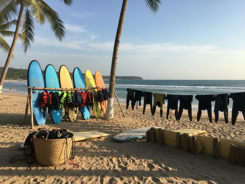 Foam longboards and rash guards organized outside certified surf school in Mexico
