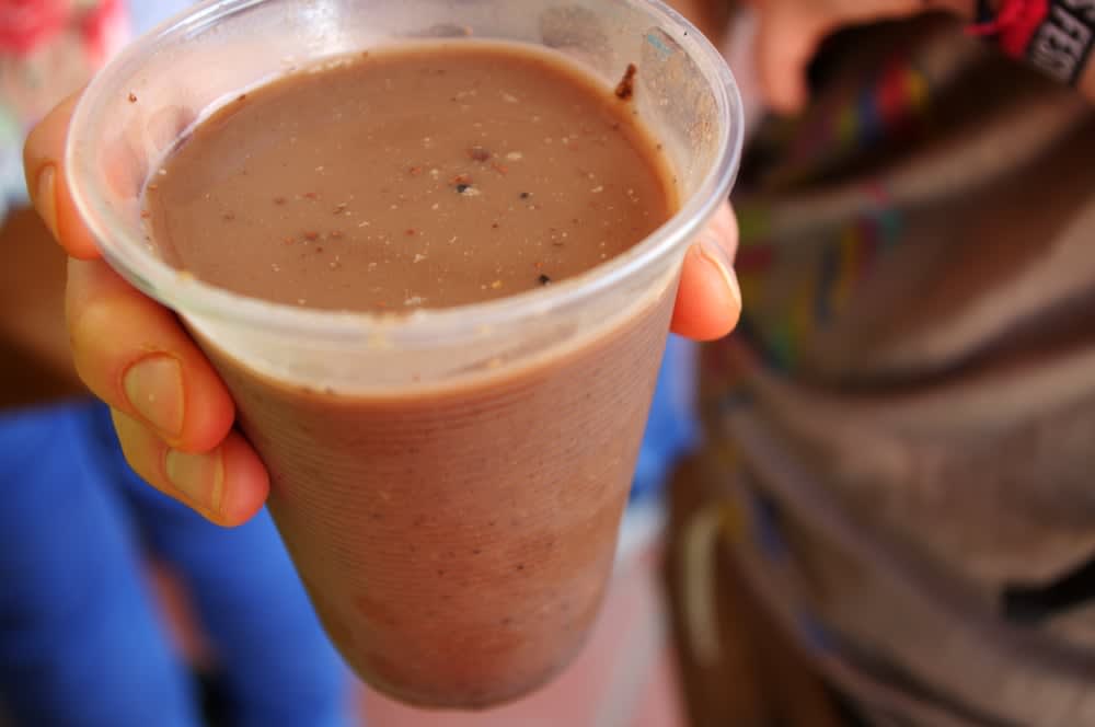 Traditional pozol drink in clay cup — fermented masa corn and cocoa beverage consumed in Villahermosa Tabasco markets