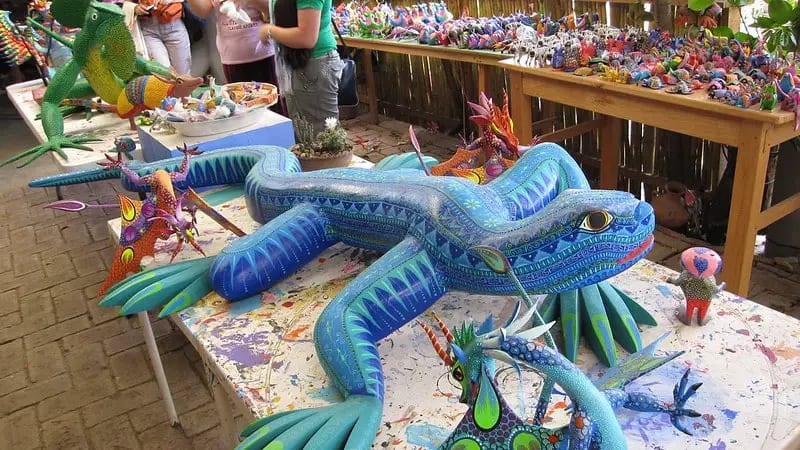 Alebrije workshop in Arrazola, Oaxaca — artisan carving and painting wooden copal figures in the village that originated the craft